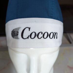 Custom embroidered scrub cap with Cocoon company logo branding